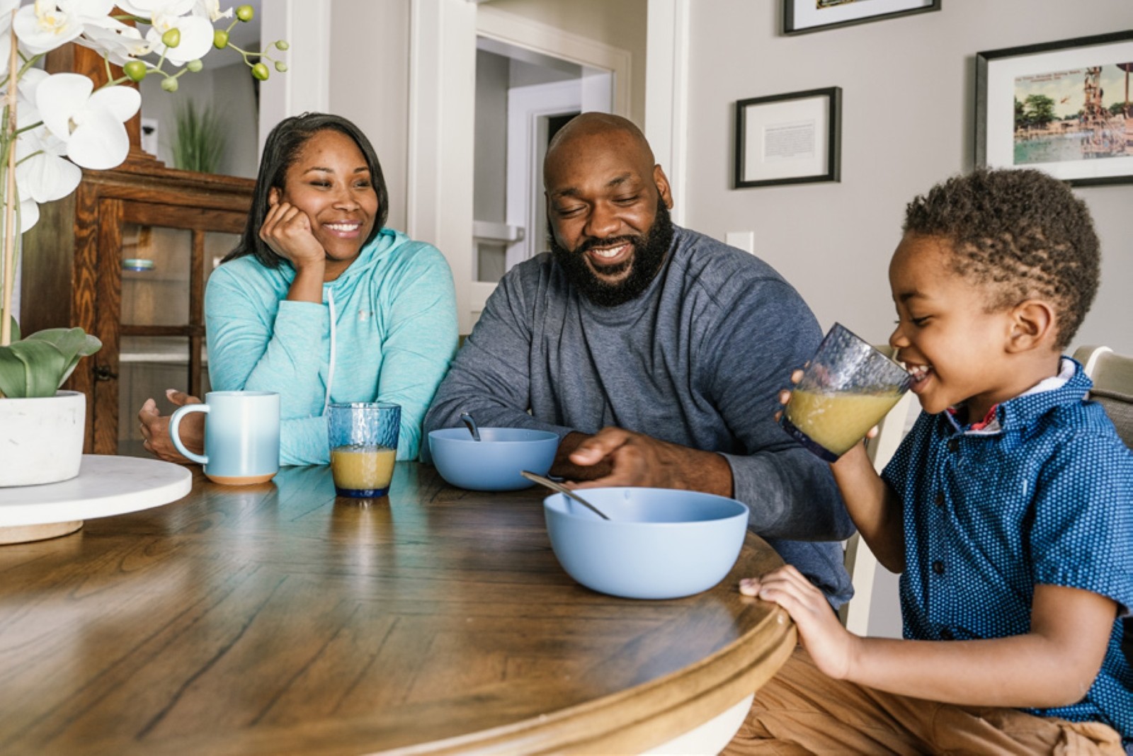 Family together at breakfast table in their home.