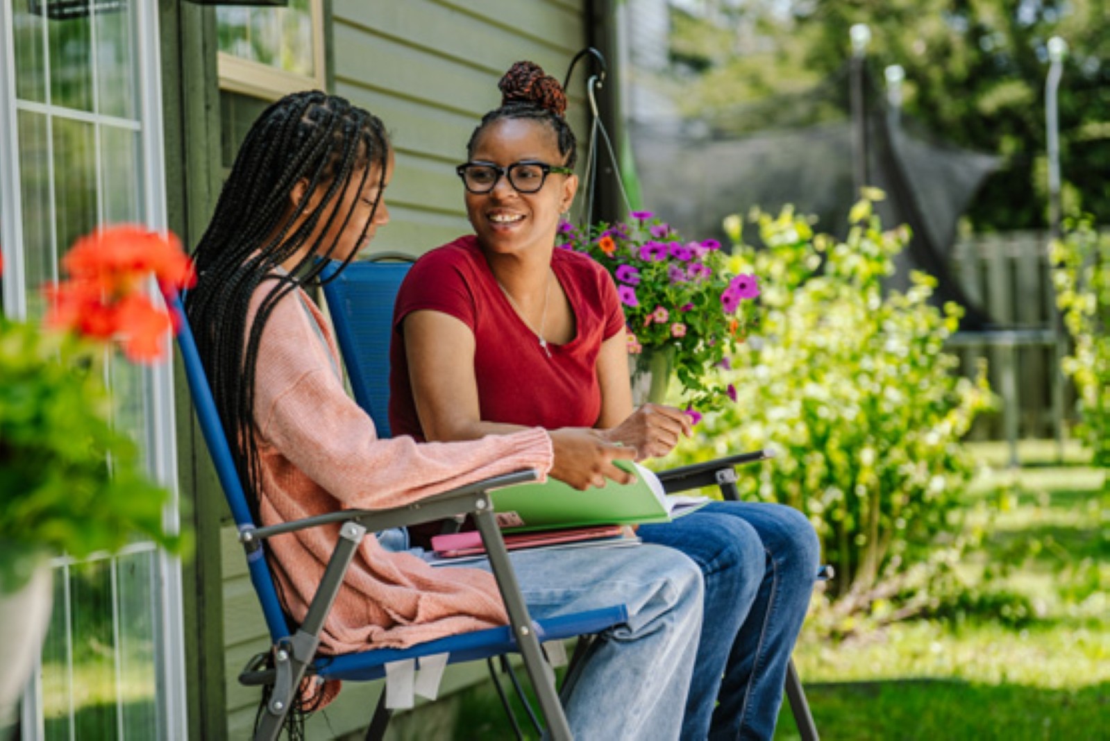 Mom and daughter in backyard at their home